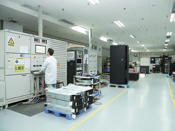 UPSBOSS technician inspecting UPS power module in laboratory